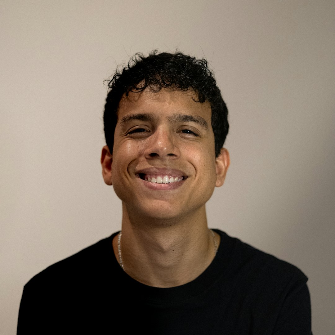 A smiling man in a black shirt